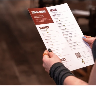 A guest holding the La Divina lunch menu