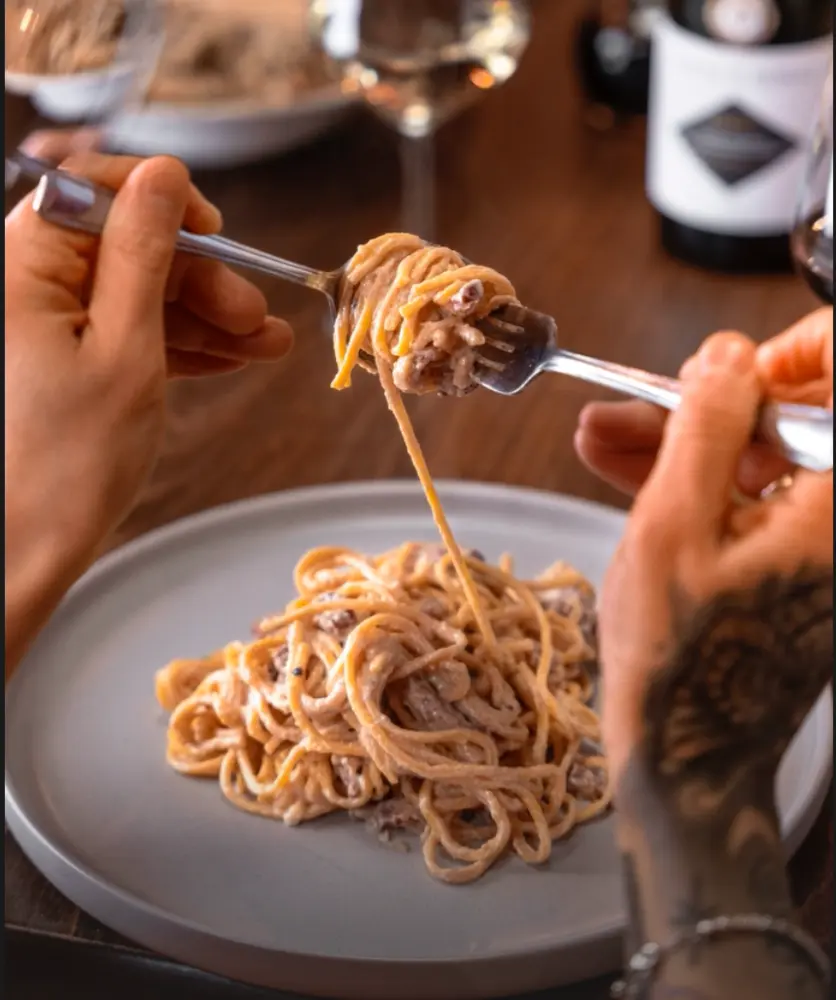 Guests sharing pasta at La Divina Italian Restaurant in Islington