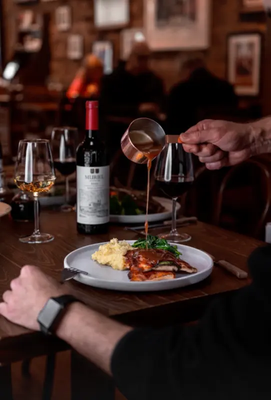 Wine being served with dinner inside La Divina on Upper Street